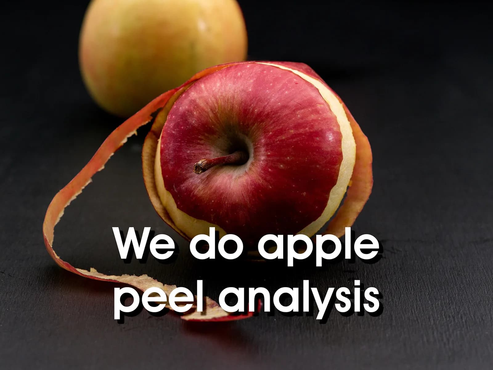 A red apple with its peel spiralling off, captioned 'We do apple peel analysis'
