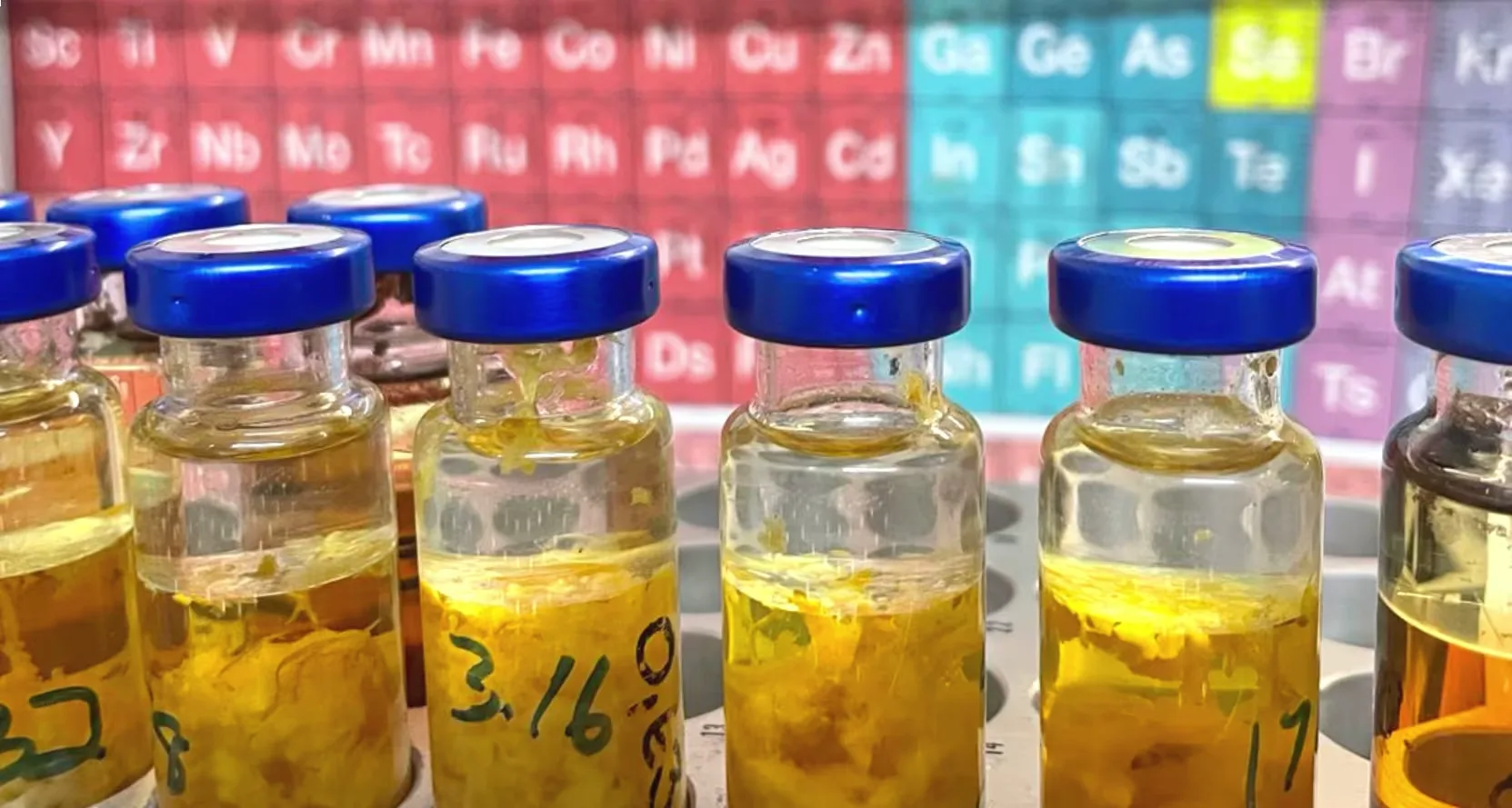 A periodic table flanked by a beaker.